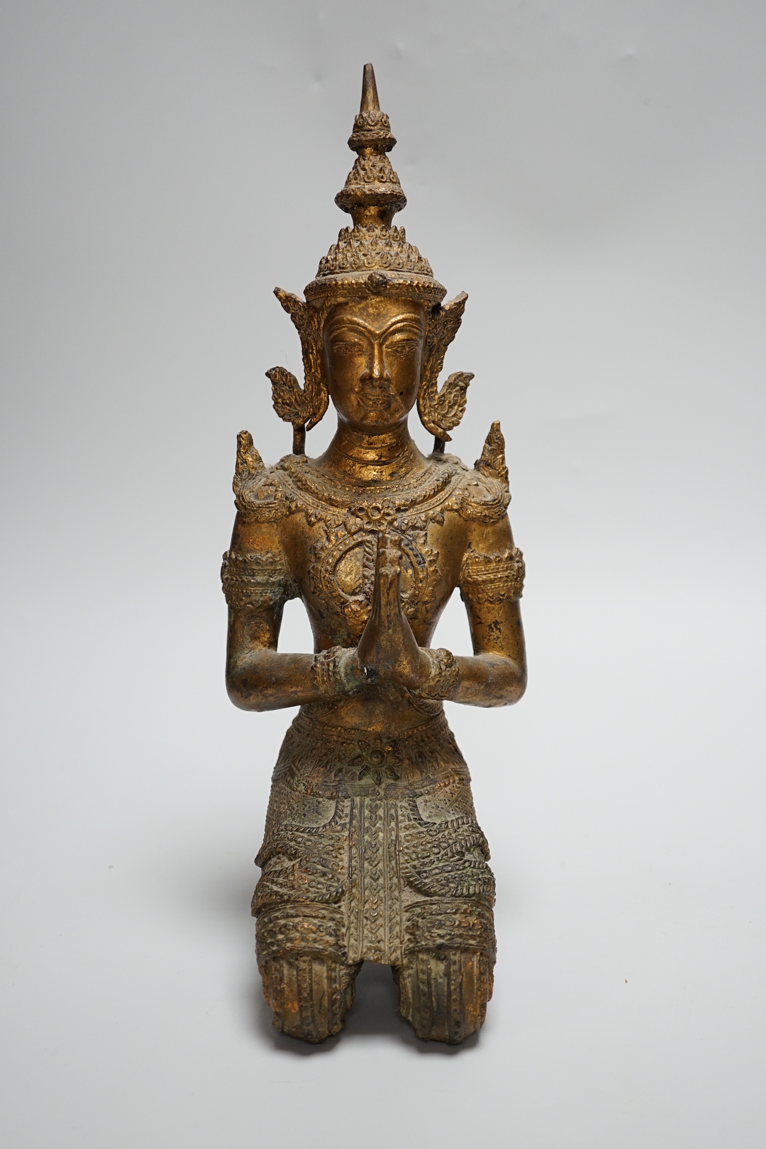 A Thai kneeling Buddha in gilt bronze, 34cm